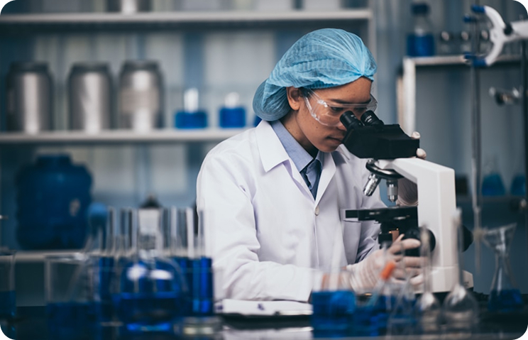 Lab scientist using microscope